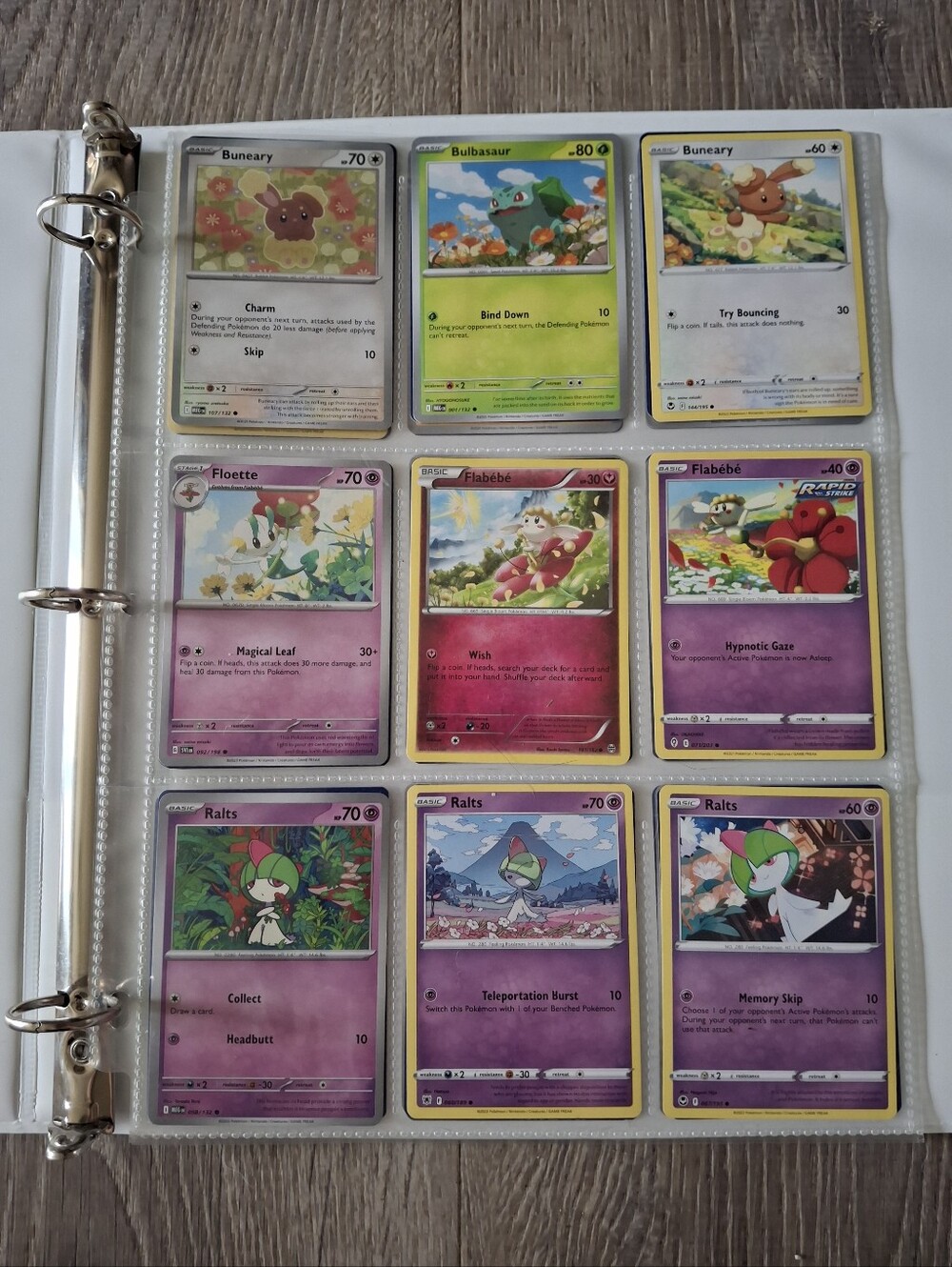 flower themed Pokemon trading cards and green binder